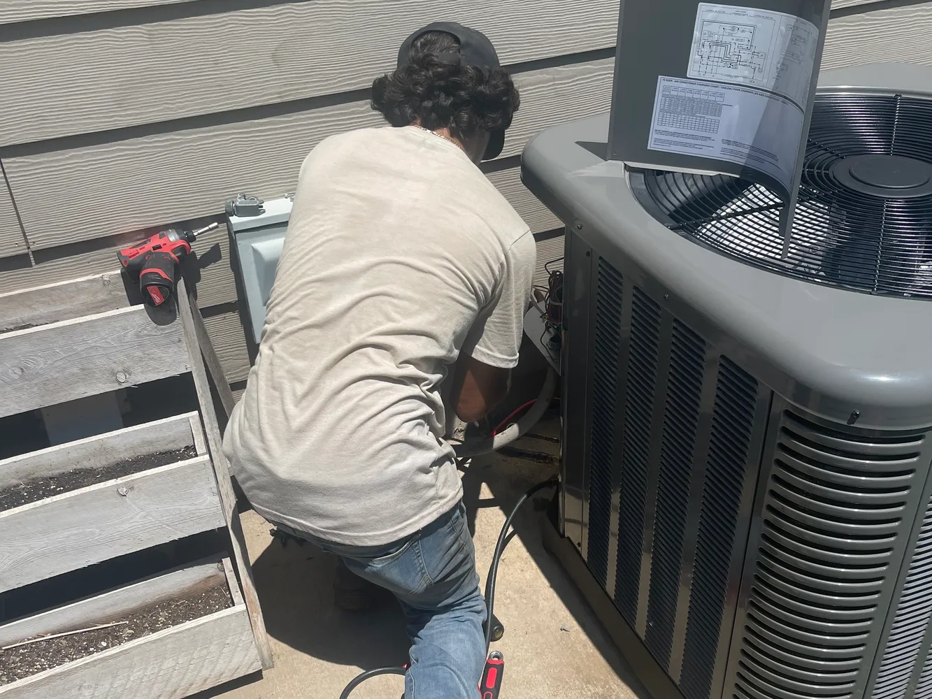 cr=w_1333,h_1000 Technician working on AC unit outside