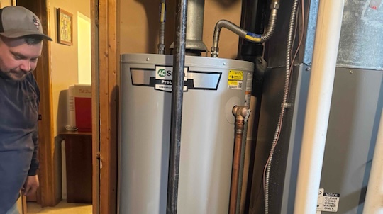 0d7b196e98e90b4a9a82266e566cb69e_6p5__McPherson_Quality_Air__LLC__McPherson_KS_67460__HVAC Technician working on water heater installation